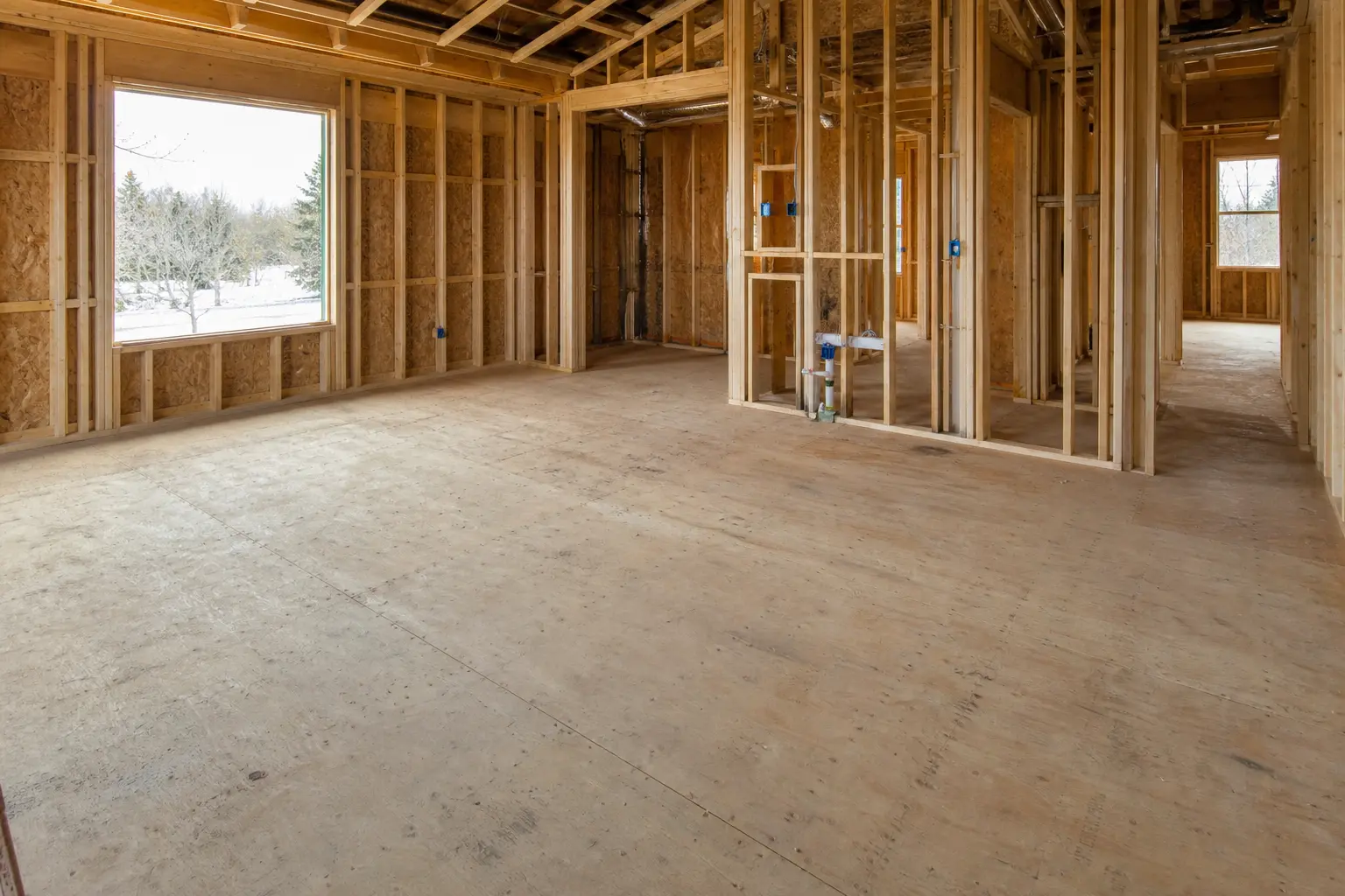 New home construction subfloor work across a residential build site